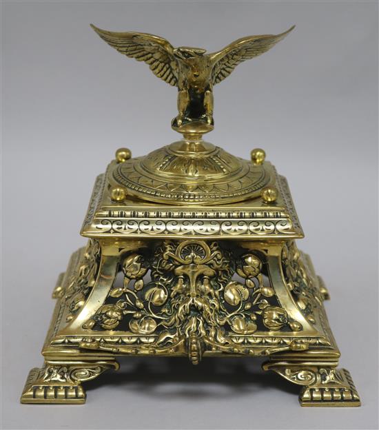 A Victorian brass inkwell with eagle mounted cover